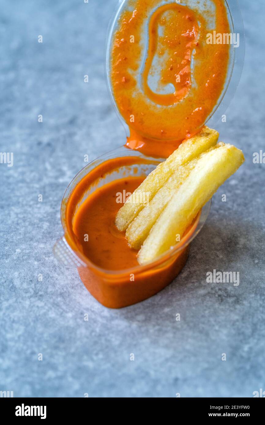 Hot Spicy Aioli Sauce with Potatoes in Plastic Cup. Take Away Fast Food