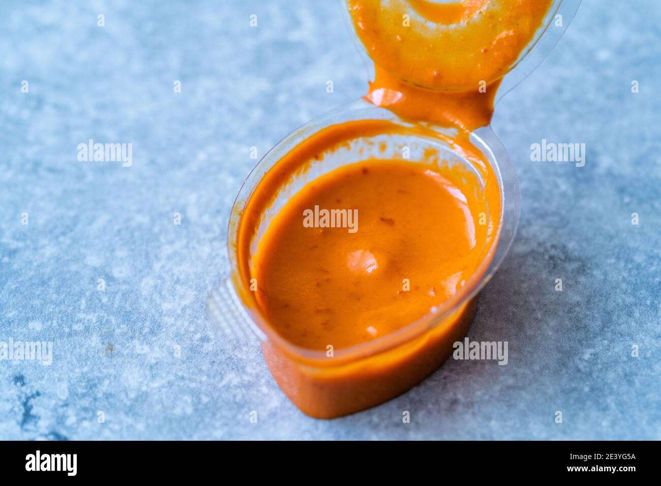 Hot Spicy Aioli Sauce in Plastic Cup. Take Away Fast Food Side Dish