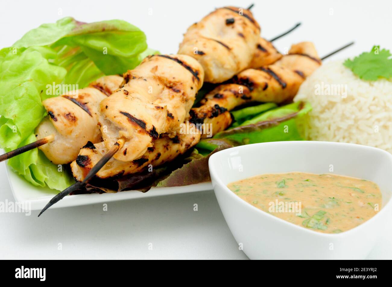grilled chicken with bamboo skewers with a peanut dipping sauce Stock