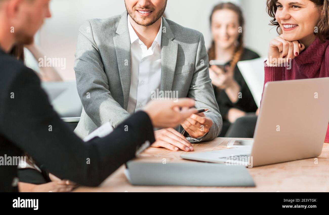 working group is discussing something while sitting at your Desk Stock Photo