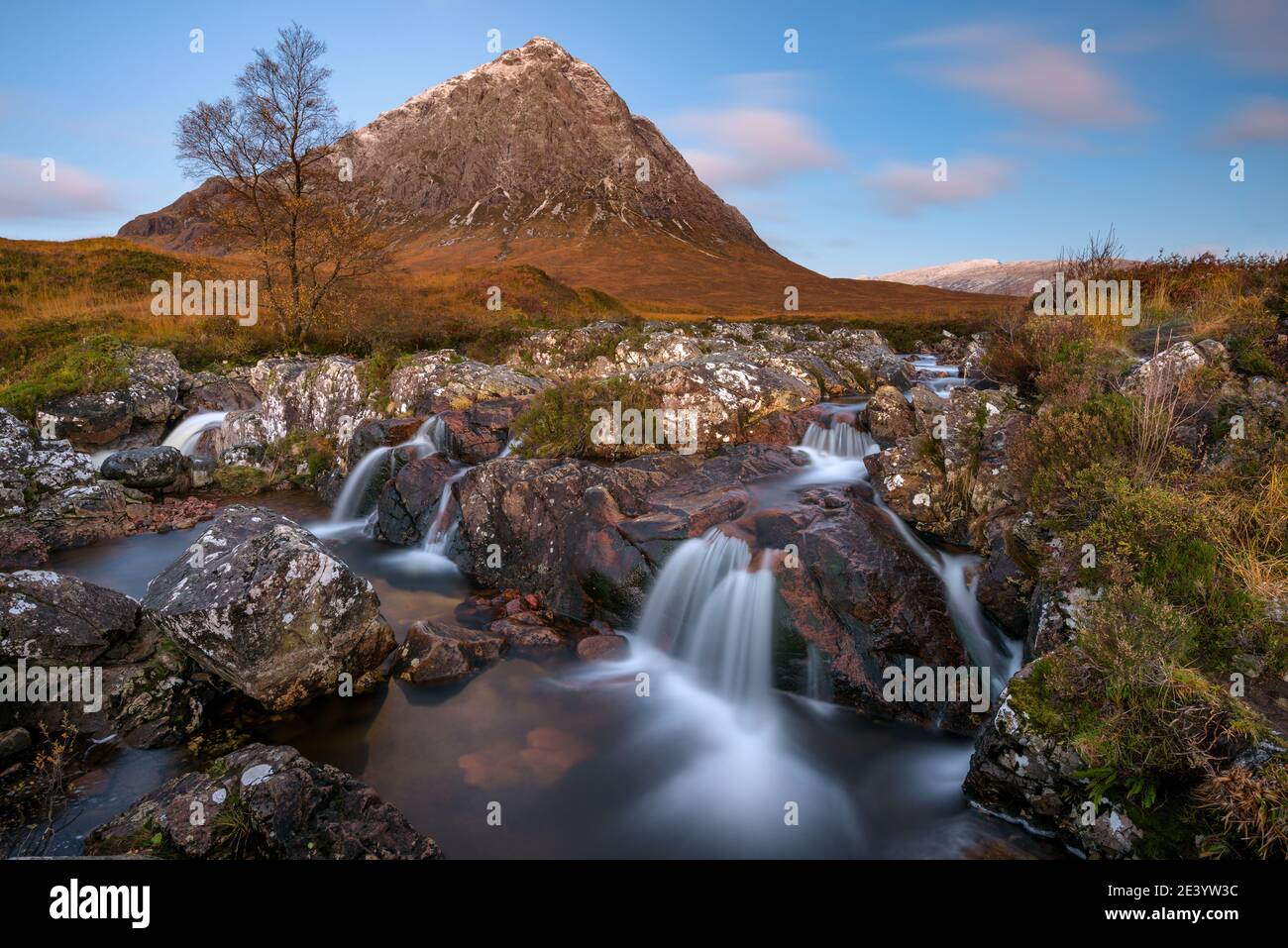 Beautiful Scotland waterfall with blue sky and snowcapped mountain. Taken at Buachaille Etive mor, Glencoe, Scottish Highlands. Stock Photo