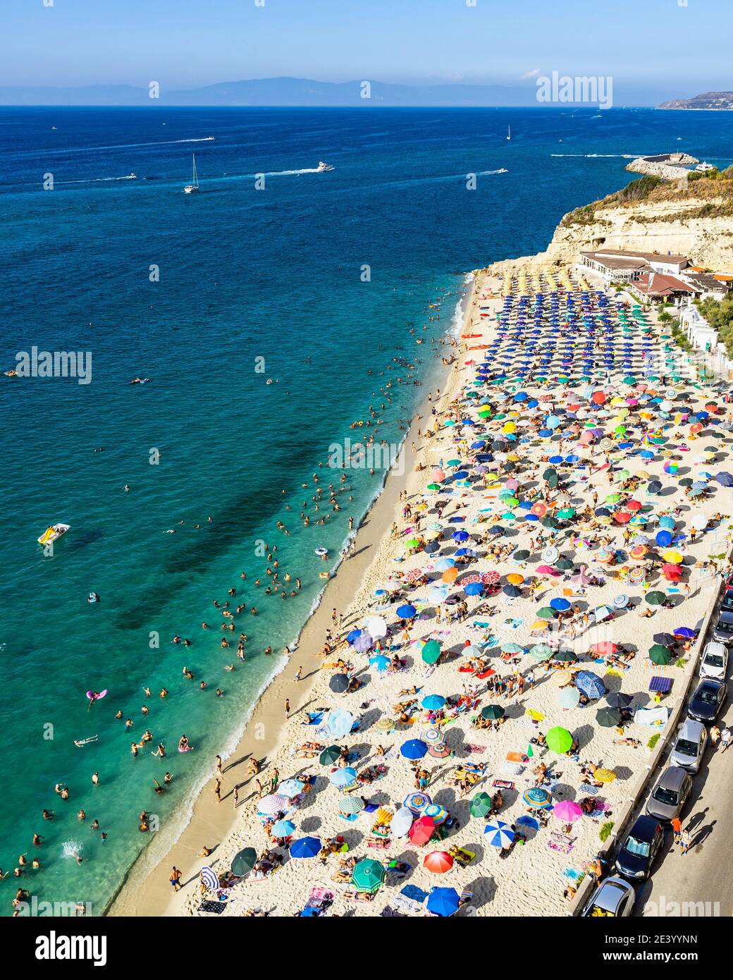 Aerial view of Tropea's crowded beach full of vacationers during summer, Calabria, Italy Stock Photo