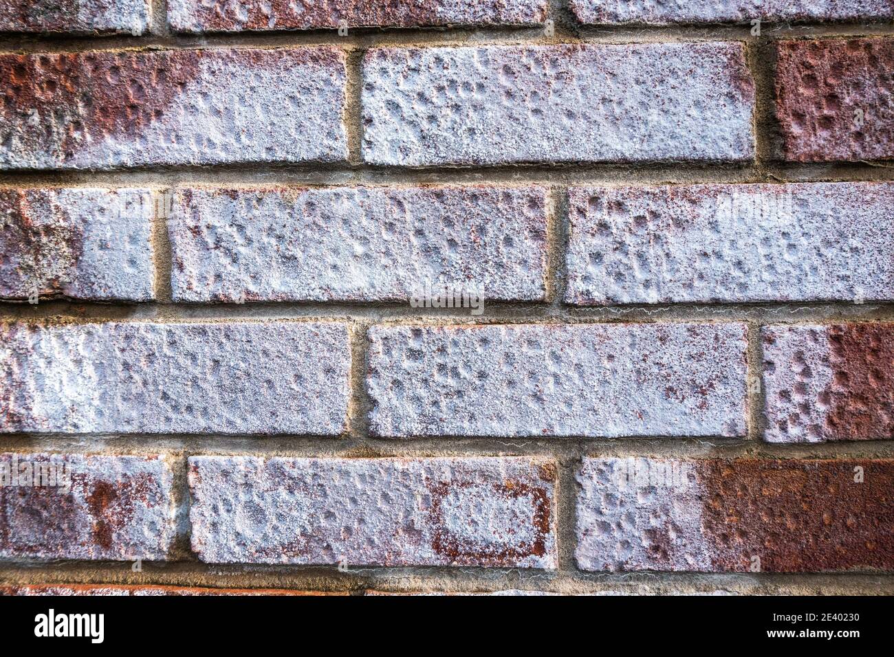 Efflorescence crystalline salt deposits on porous brick wall Stock