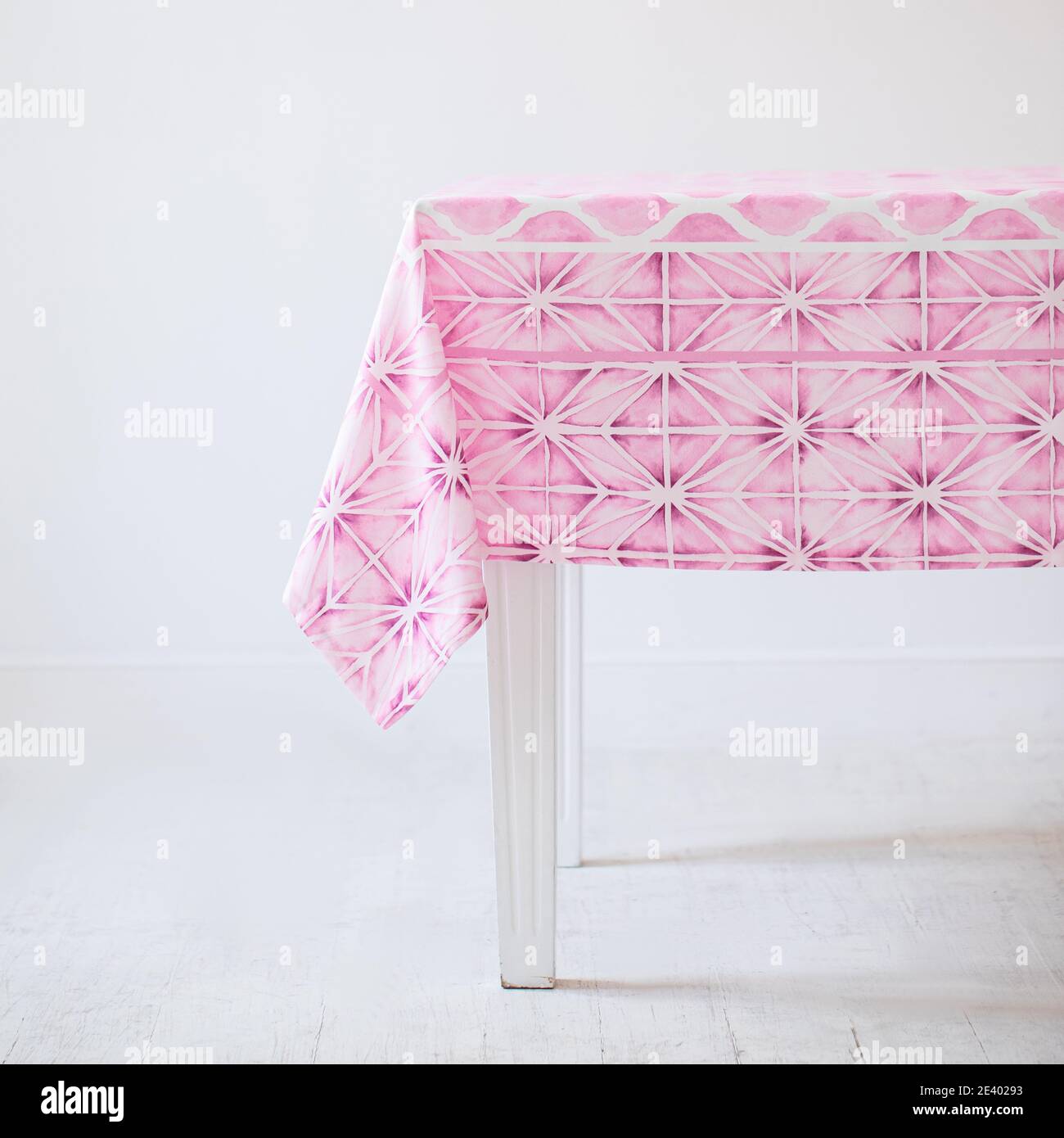 Pink Tablecloth Pattern Decorative tablecloth with pink patterns on a table on a white ...