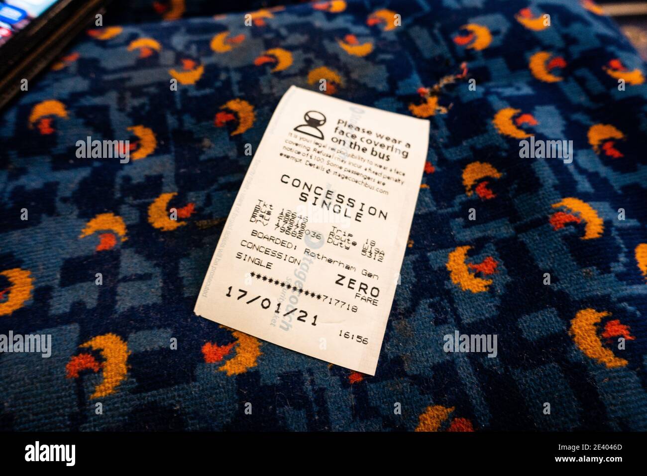 Old aged pensioners free bus pass ticket left on a bus seat Stock Photo