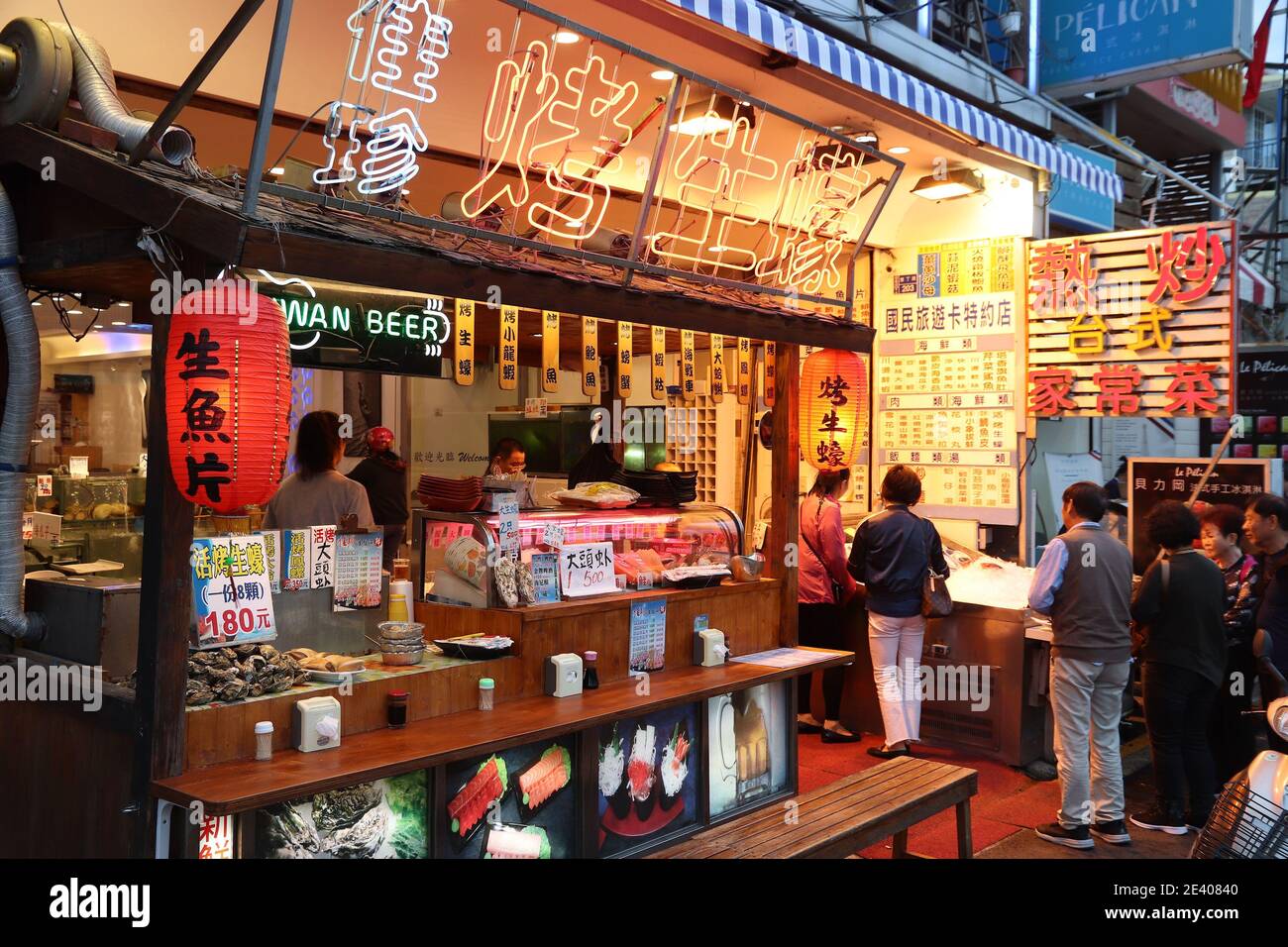 KENTING, TAIWAN - NOVEMBER 28, 2018: People visit sea food restaurant at Kenting Street Night Market in Taiwan. Night food markets are a big part of T Stock Photo