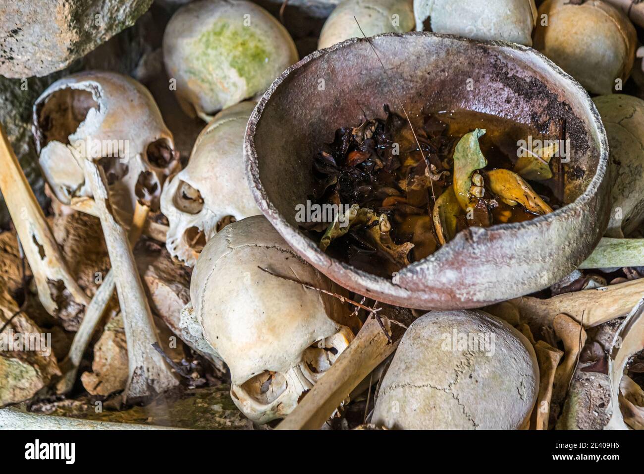 Skulls of cannibals left behind in a cave on the island of Pana Wara Wara in Papua New Guinea Stock Photo