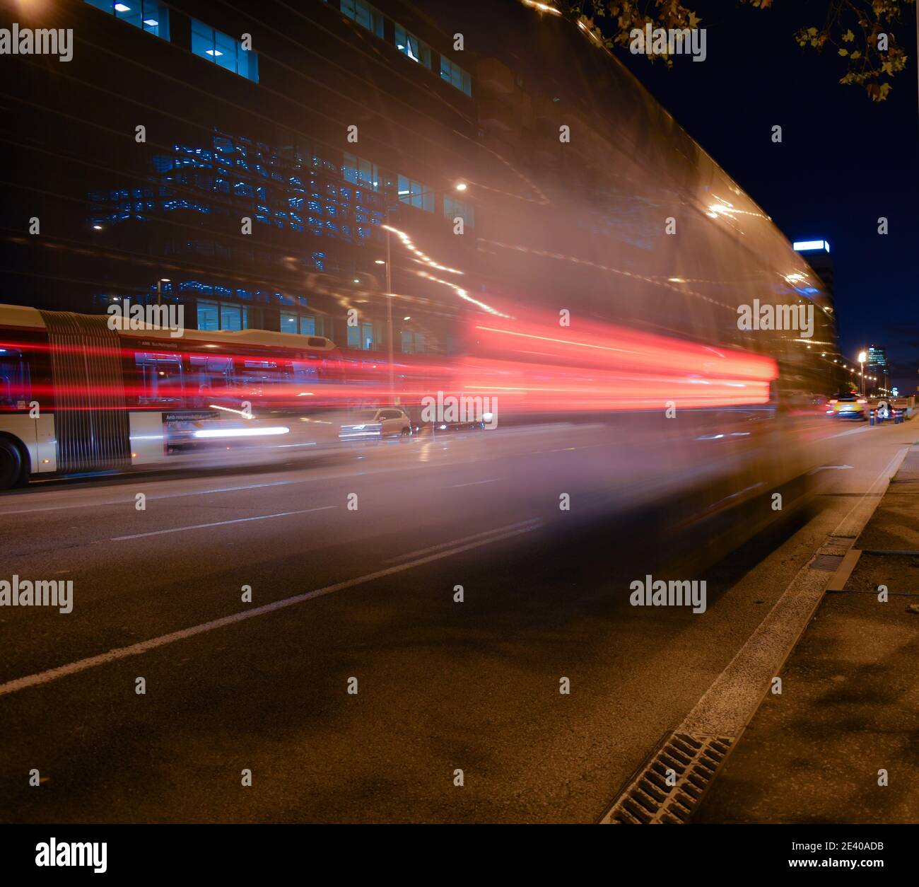 Moving bus on the street in the night with motion blur Stock Photo - Alamy