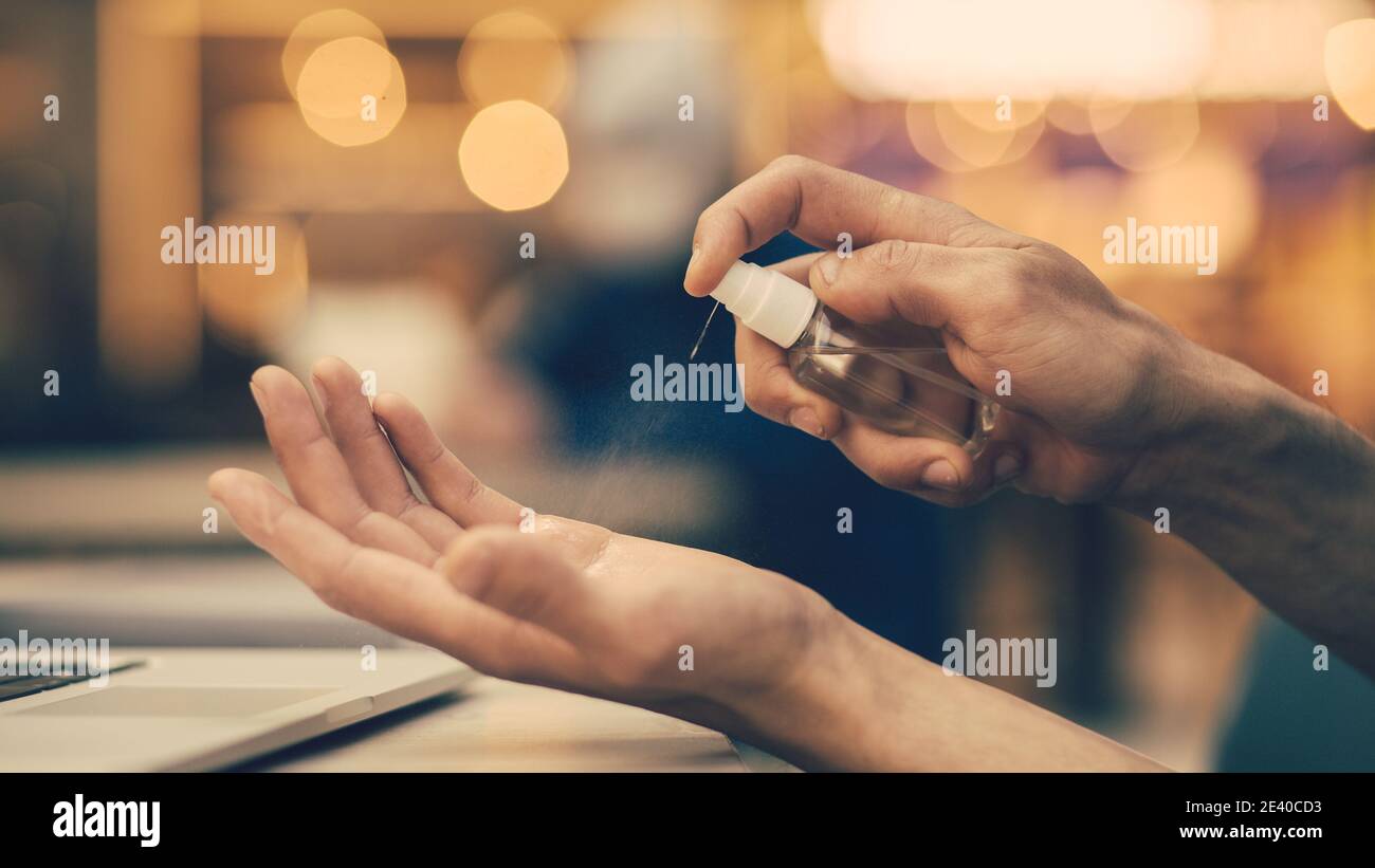 close up. man uses an antiseptic hand spray Stock Photo Alamy