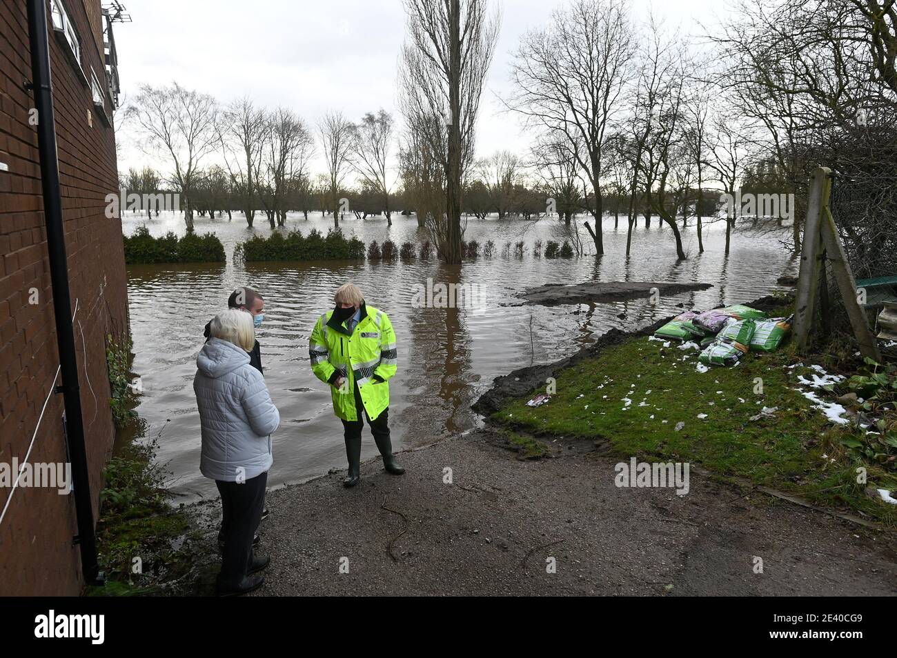 Britain's Prime Minister Boris Johnson talks with local residents during his visit to Withington in Manchester, as Storm Christoph brings heavy rains and flooding across the country, Britain January 21, 2021. Paul Ellis/Pool via REUTERS Stock Photo