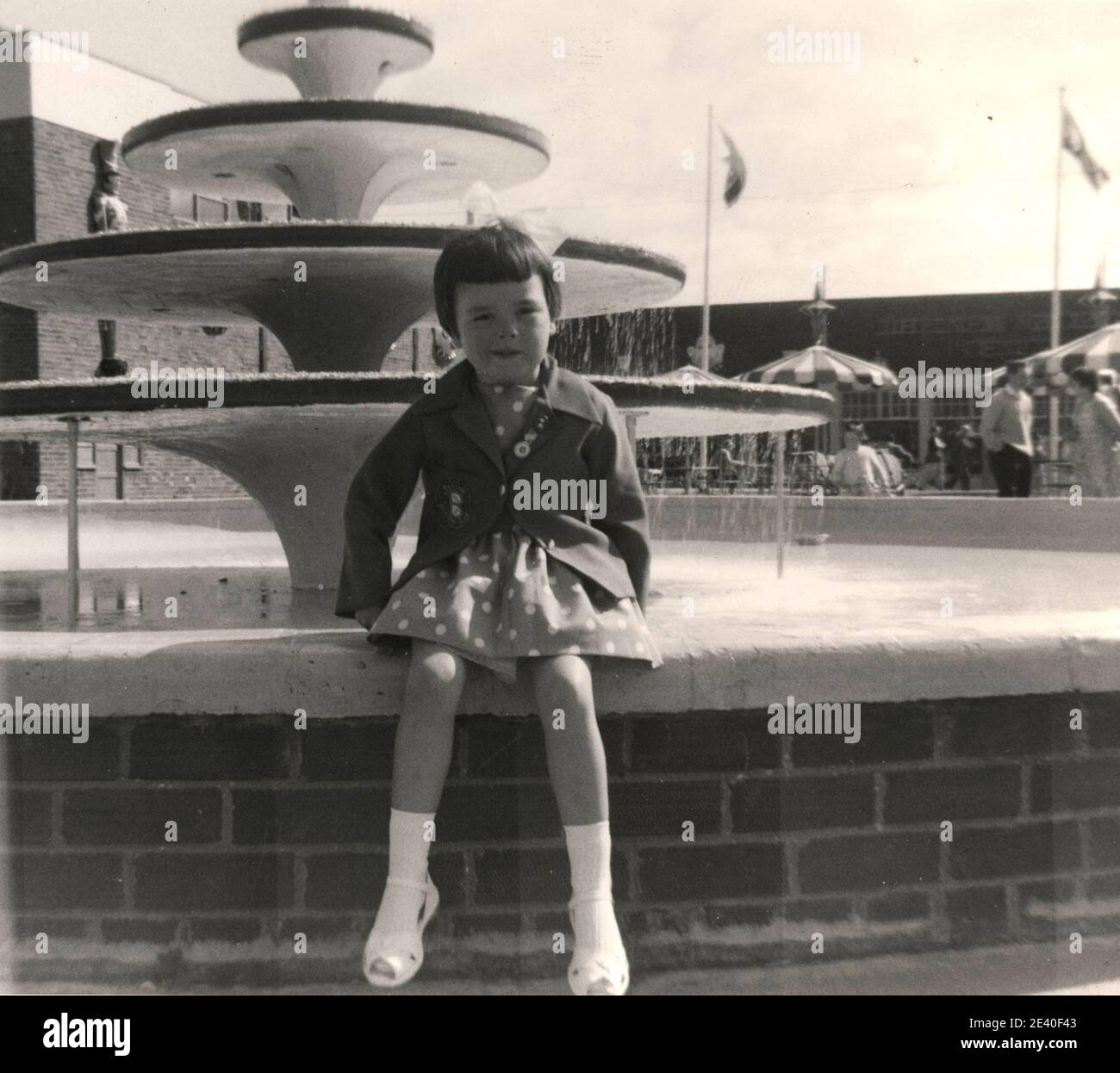 Five year old girl by the fountain at Butlin's holiday camp on Filey, Yorkshire, UK Stock Photo