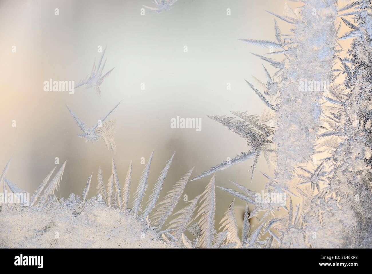 Frost patterns on the glass of the winter window in freezing cold ...