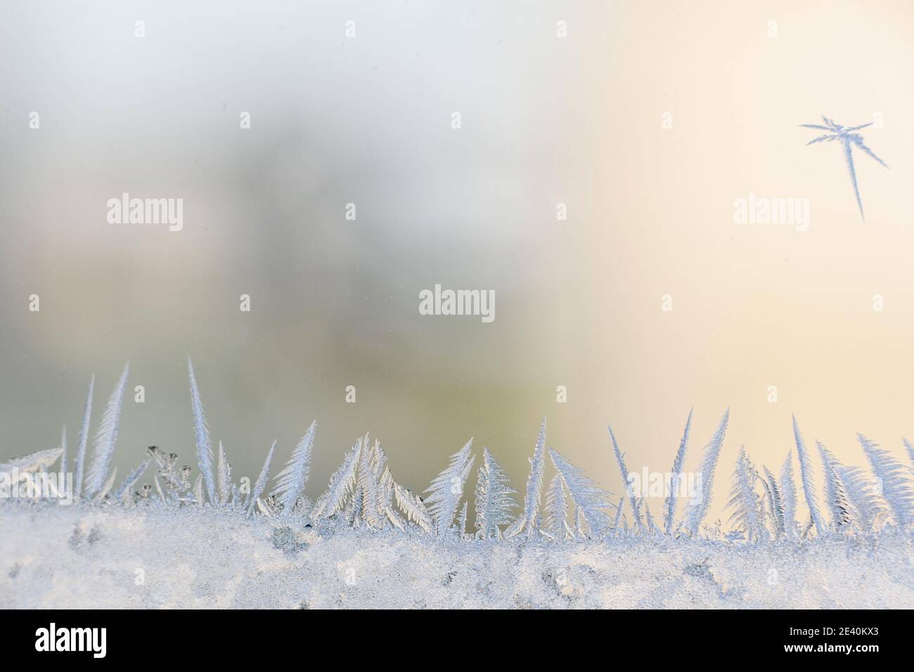 Frost patterns on the glass of the winter window in freezing cold ...