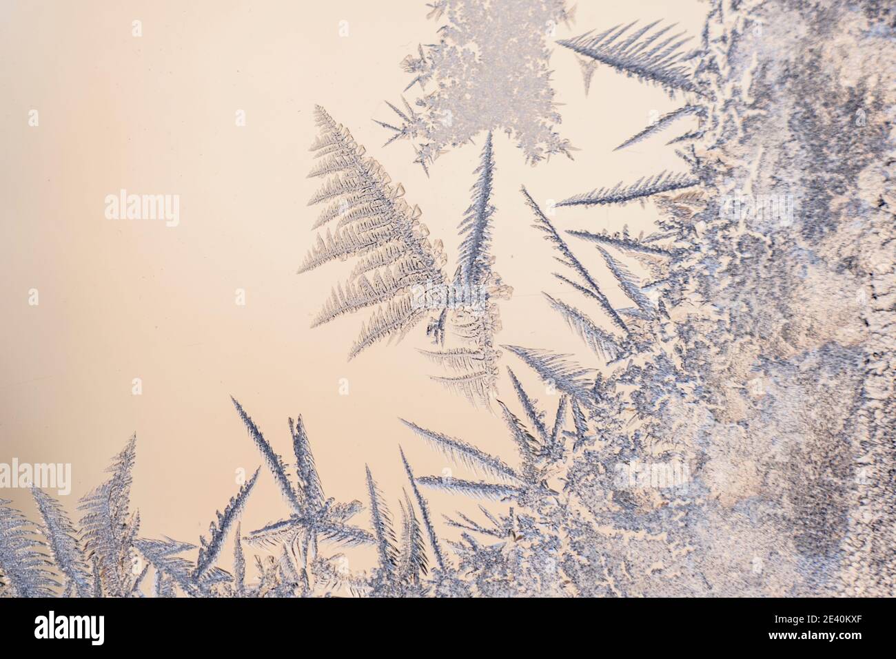 Frost patterns on the glass of the winter window in freezing cold ...