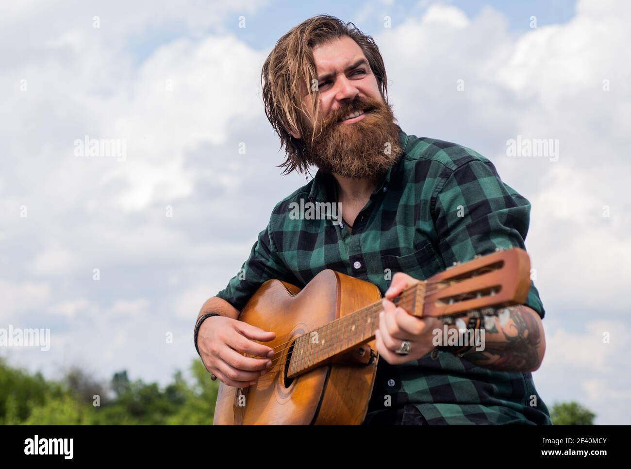 favorite tune. country music concept. bearded man play acoustic guitar.  casual guy express human emotions. hipster with long hair and moustache  guitarist. male guitarist with musical instrument Stock Photo - Alamy