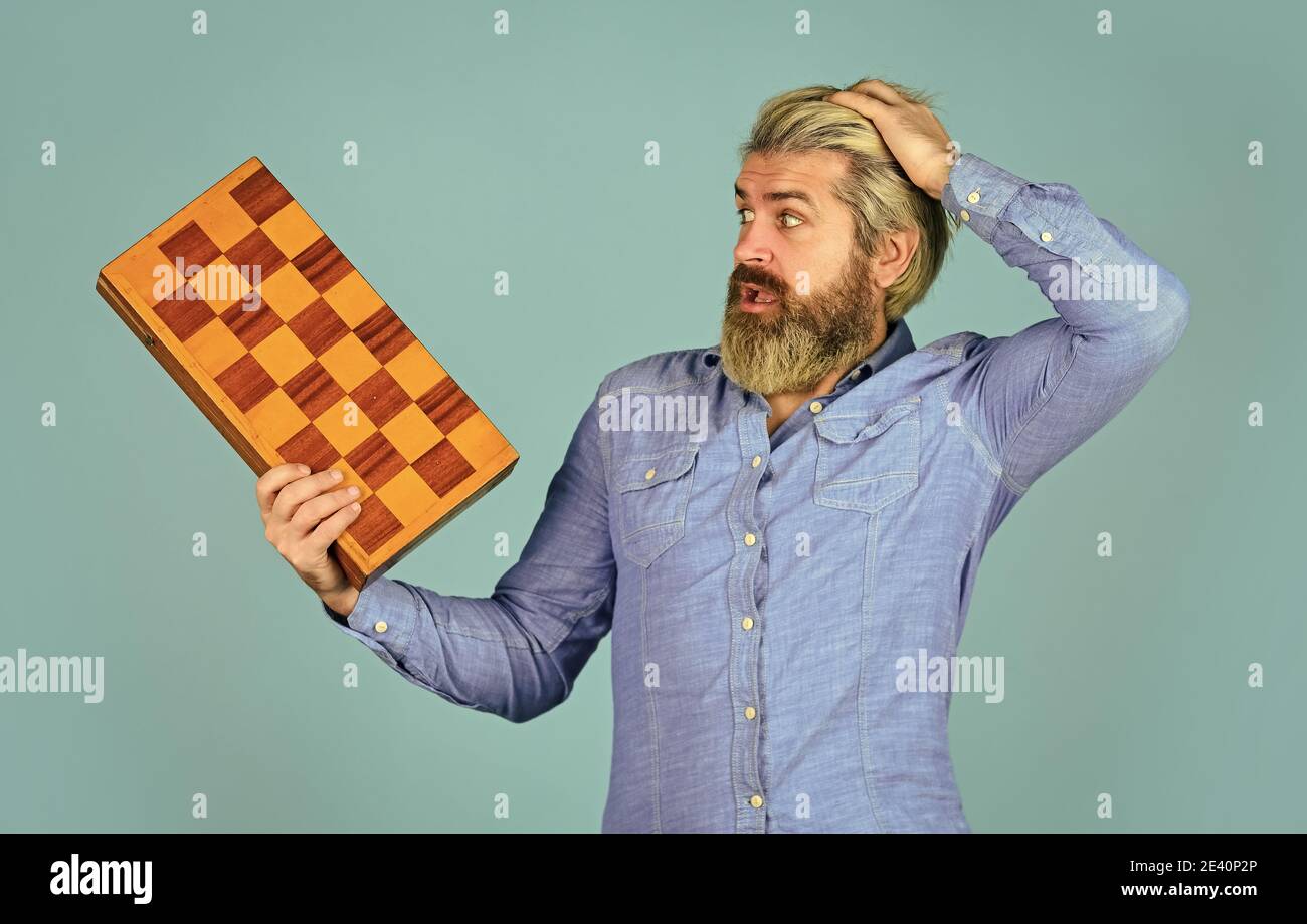 oh my god. intelligence quotient concept. human brain working. brainstorming concept. play chess tournament. Intelligence level measurement. level up your iq. surprised bearded man hold chess board. Stock Photo