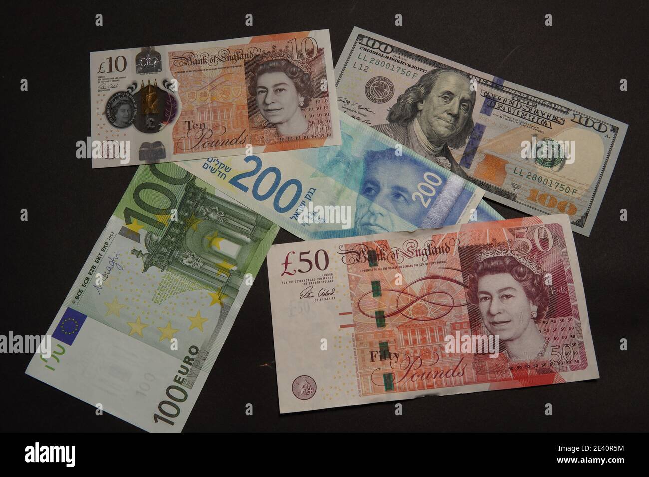 Flat lay of Euro, GBP, Israeli Shekel and Dollar banknotes on a black  surface - finance concept Stock Photo - Alamy