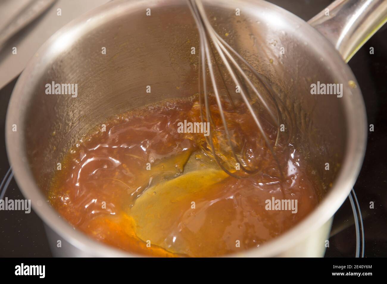 The process of making jelly from natural fruits. Heated fresh citrus fruit juice with sugar and agar. Stock Photo