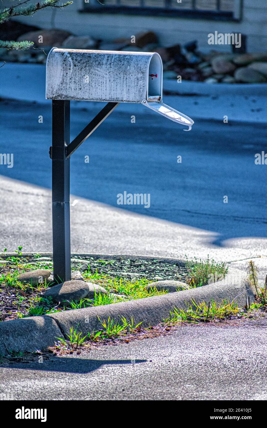 Vertical shot of a lonely old mailbox outside a bankrupt business during the pandemic. Stock Photo