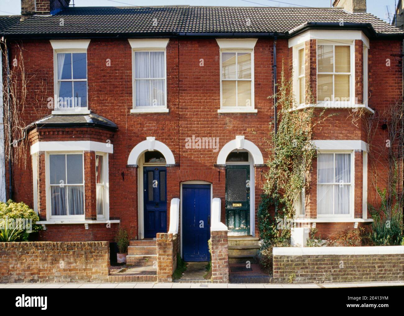 Late victorian/edwardian brick semi detached cottages with doors to