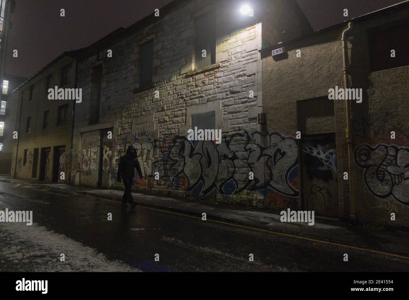 A night view of a block of flats covered in graffiti in winter Stock Photo