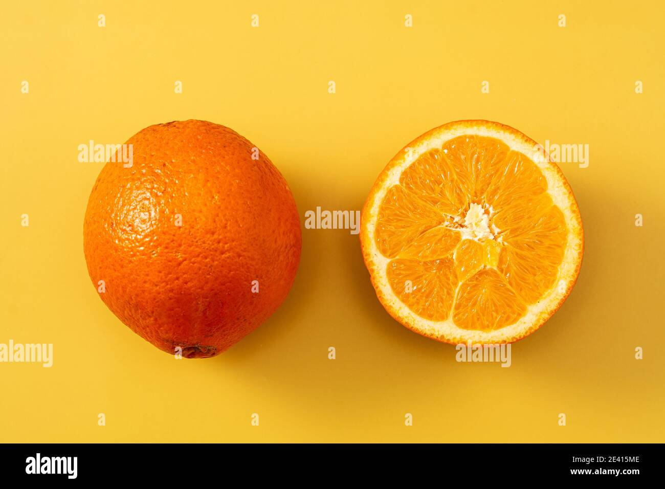 Fresh orange on yellow background Stock Photo
