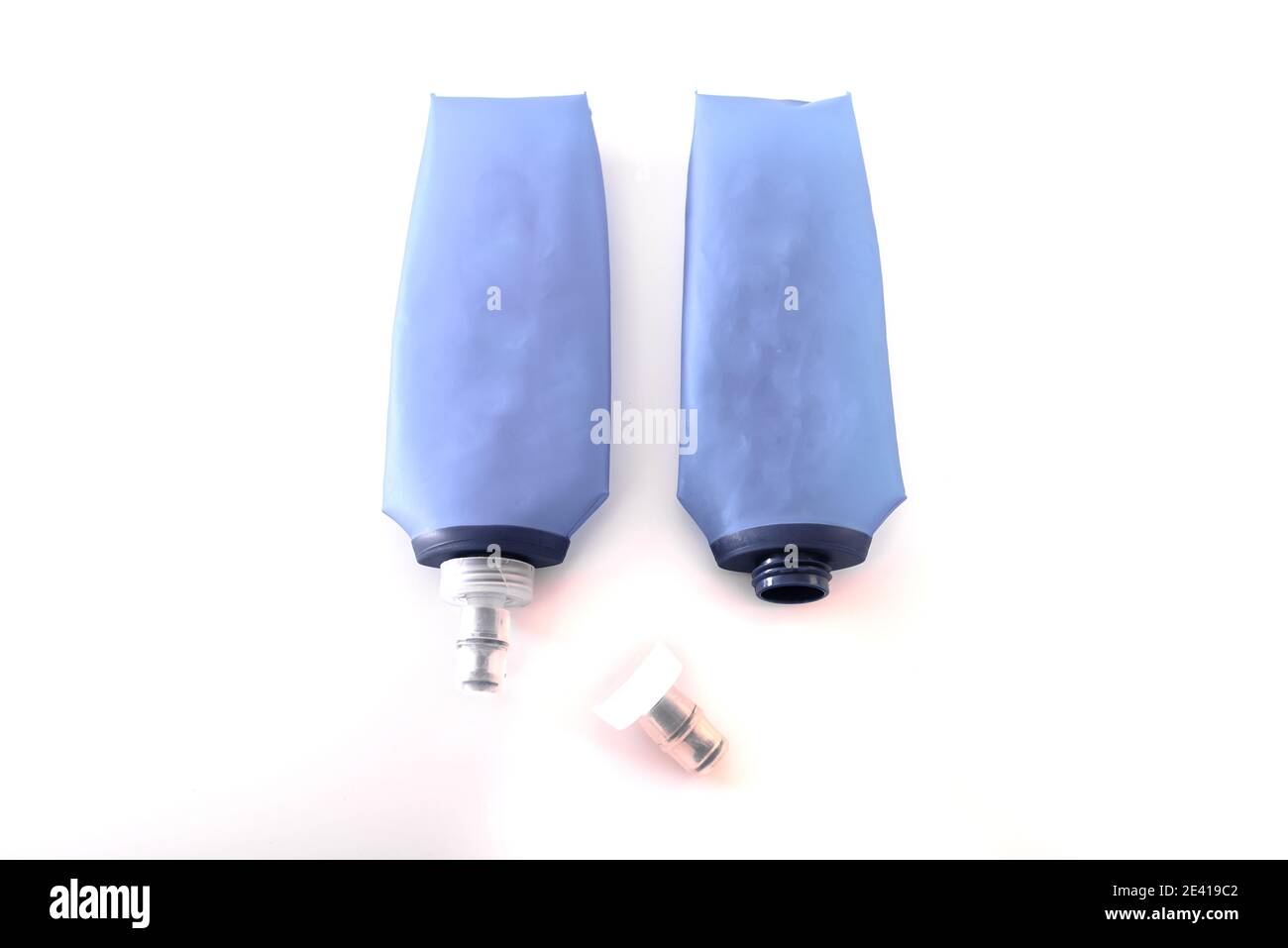 Blue plastic soft flasks, isolated on white background, must be cleaned