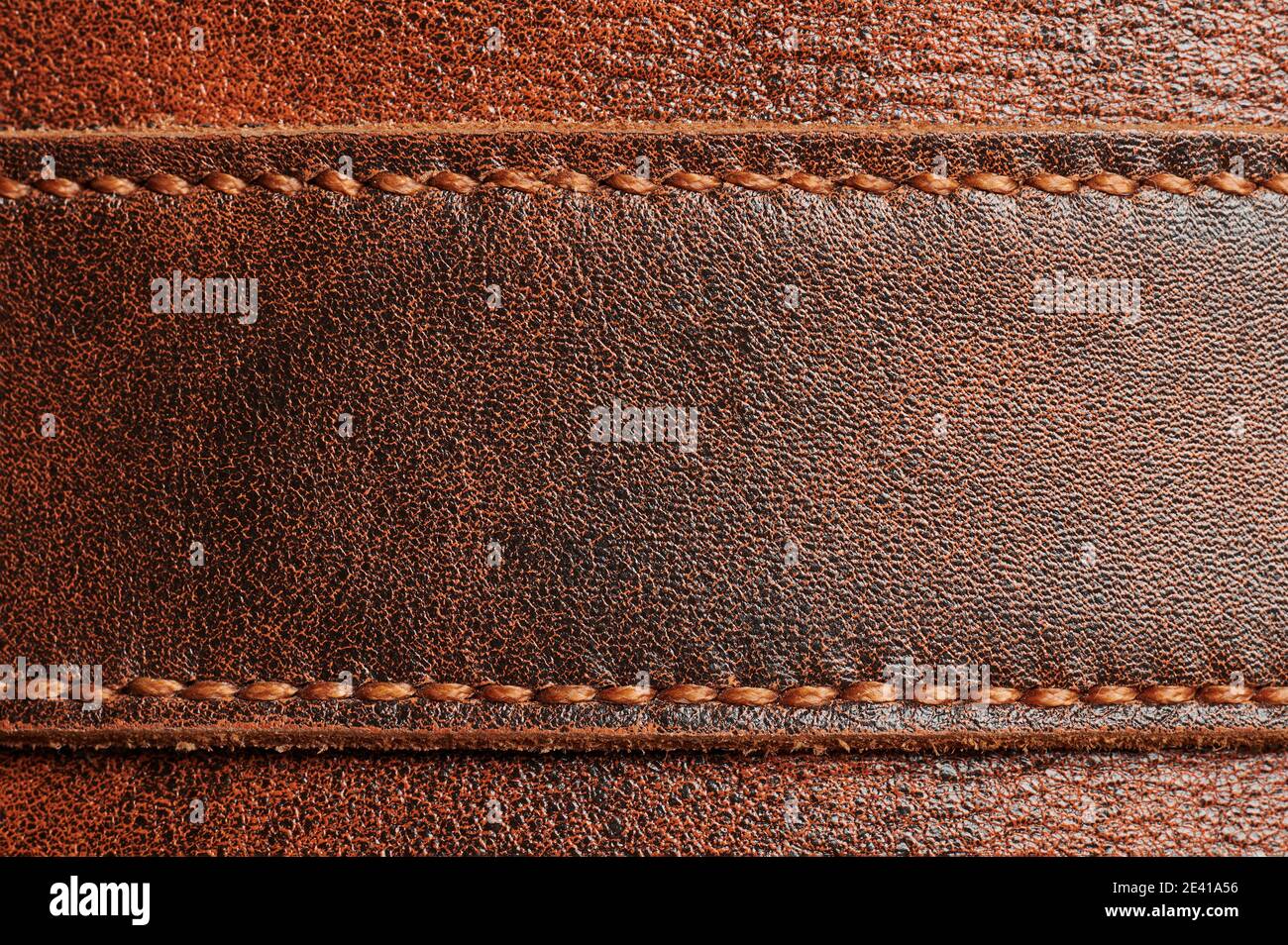 Brown leather tag with stitches macro close up view Stock Photo