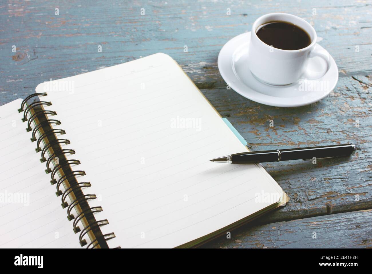 coffee with a notebook and pens on the table Stock Photo