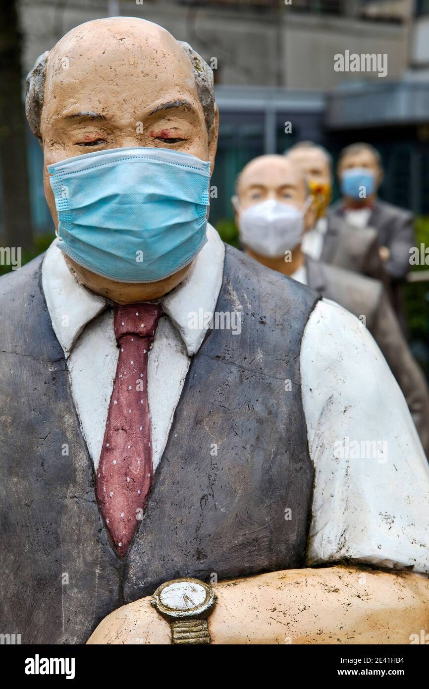 male sculptures with mask during the corona pandemic, keep distance, Germany, North Rhine-Westphalia, Ruhr Area, Witten Stock Photo