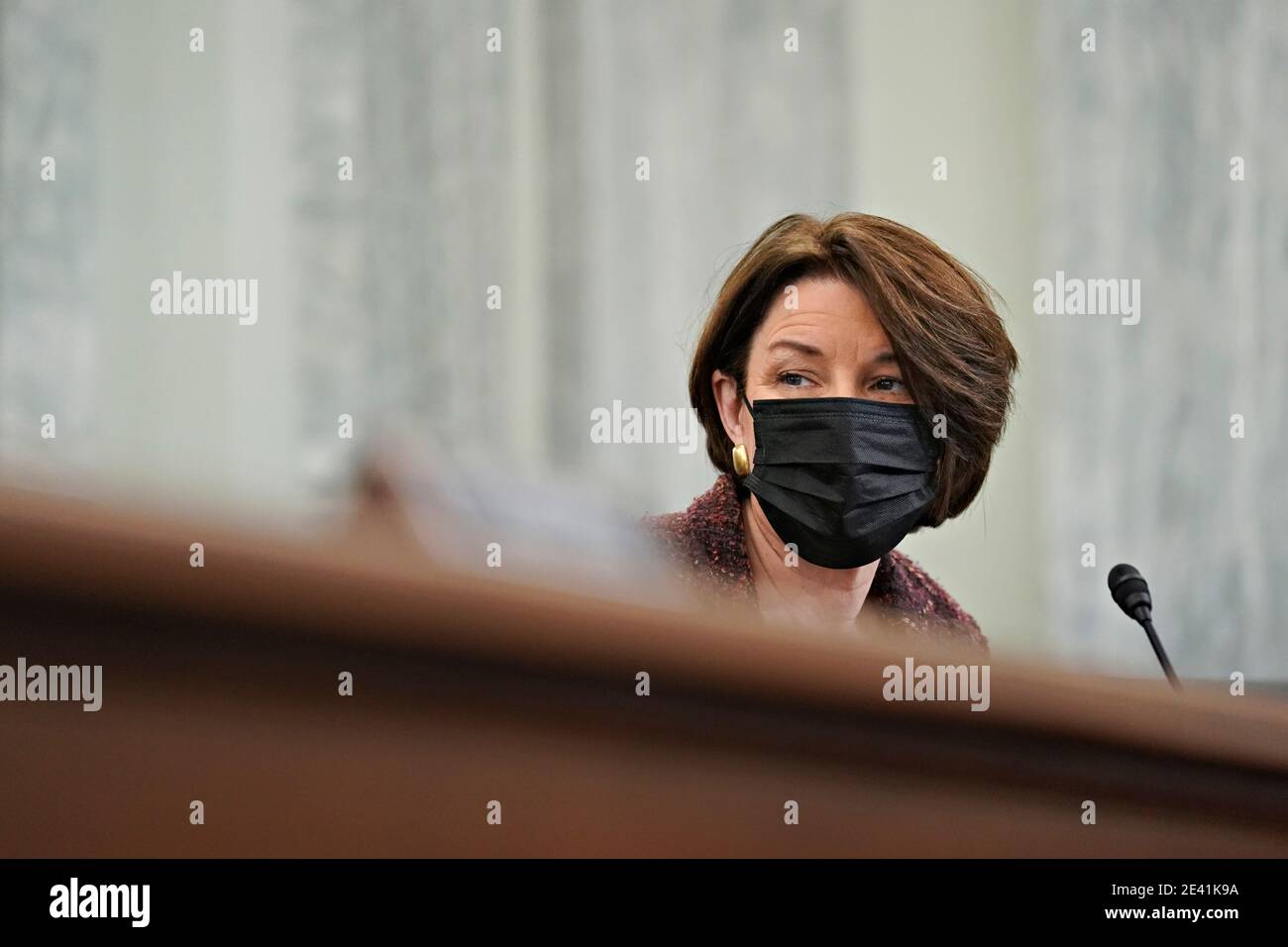 United States Senator Amy Klobuchar (Democrat of Minnesota), wears a protective mask during a Senate Commerce, Science and Transportation Committee confirmation hearing for U.S. Secretary of Transportation nominee Pete Buttigieg in Washington, DC, U.S., on Thursday, Jan. 21, 2021. Buttigieg, is pledging to carry out the administration's ambitious agenda to rebuild the nation's infrastructure, calling it a 'generational opportunity' to create new jobs, fight economic inequality and stem climate change. Credit: Stefani Reynolds/Pool via CNP | usage worldwide Stock Photo