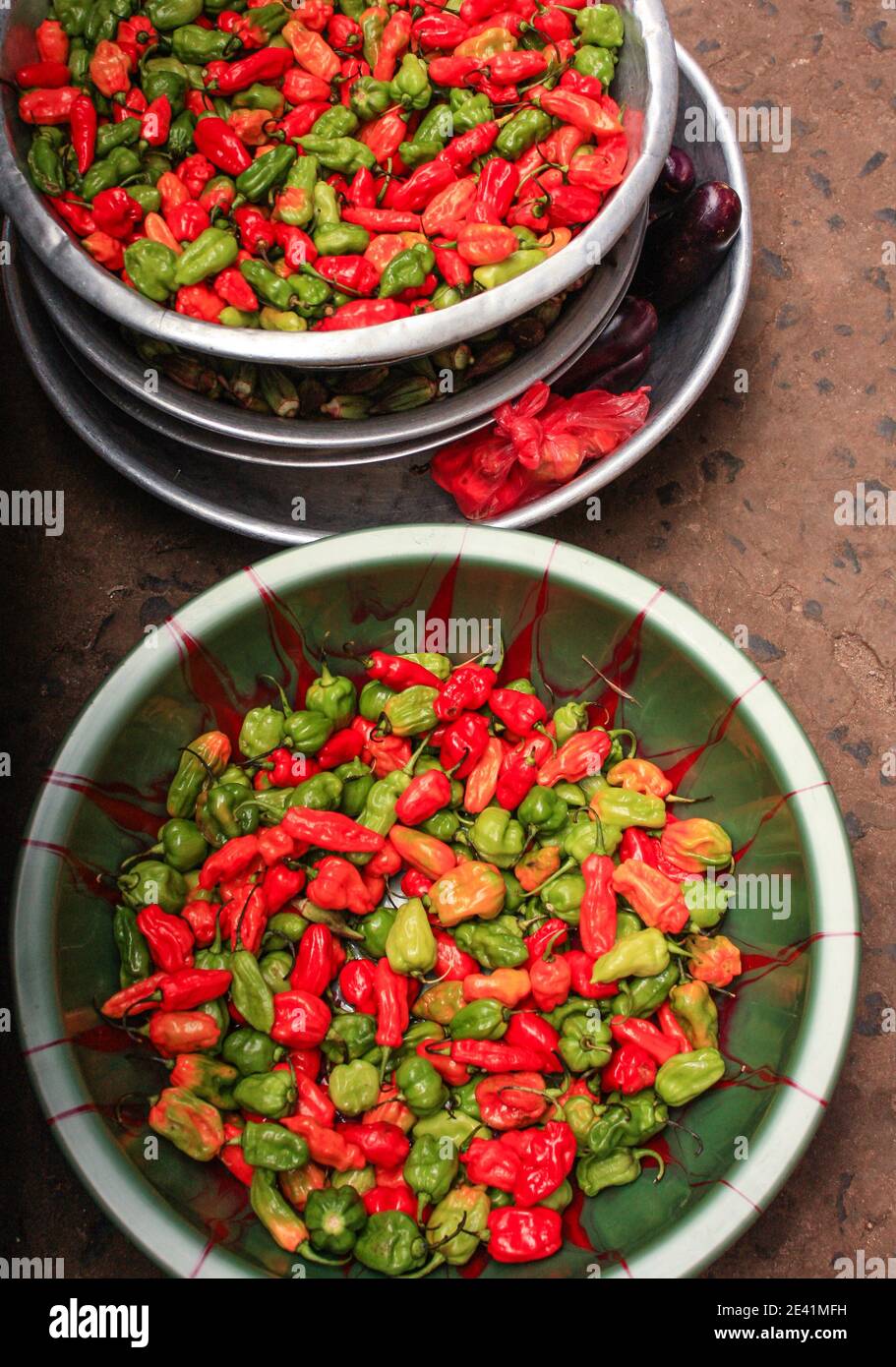 red green and yellow Hot pepper sold at a market in freetown sierra leone Stock Photo
