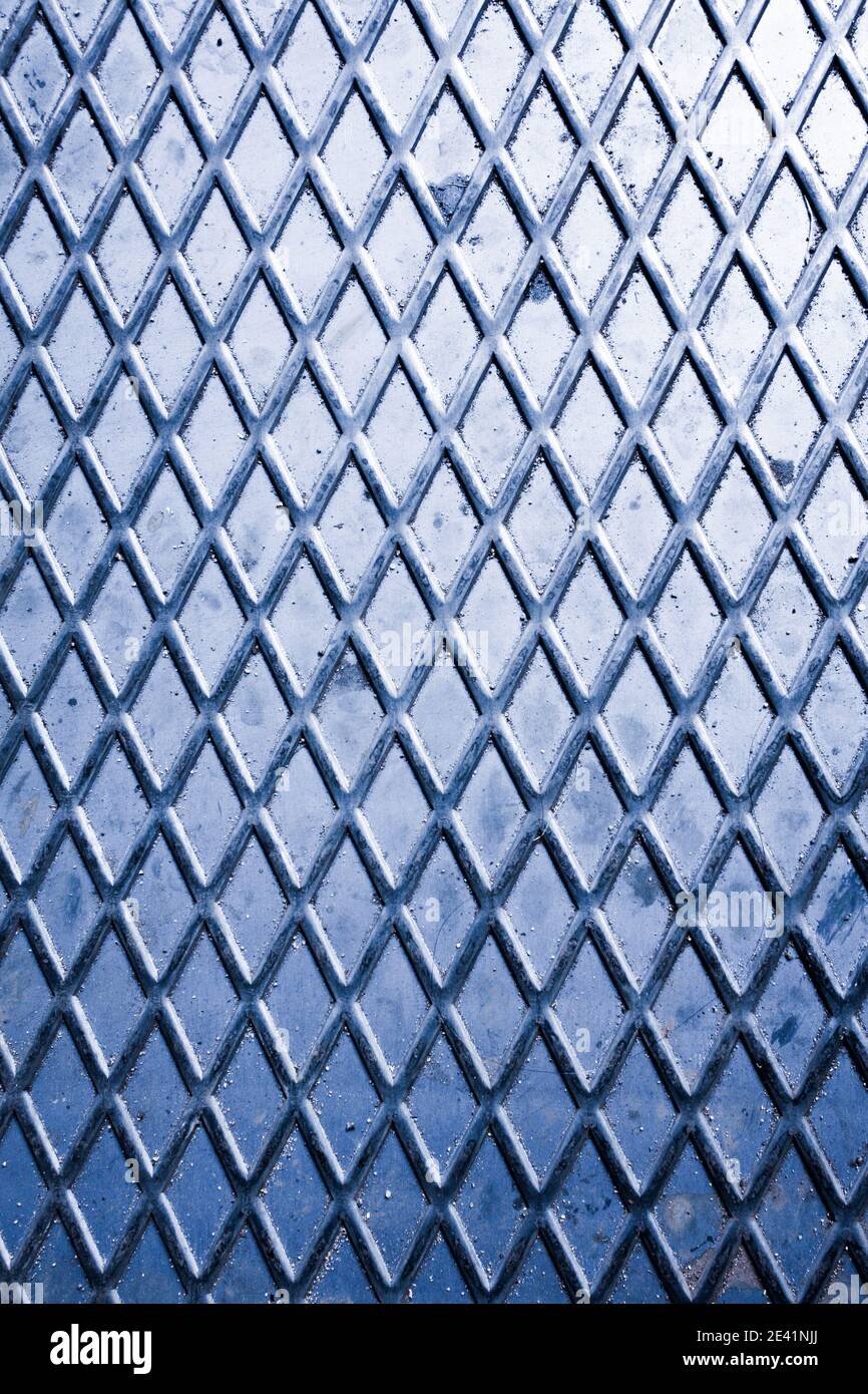 Diamond pattern from metal sheet tinted blue for background Stock Photo