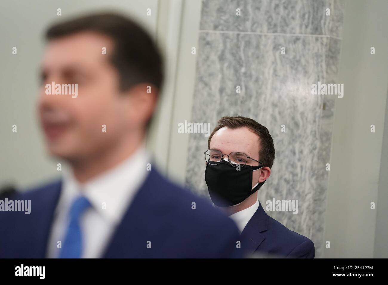 Pete Buttigieg, U.S. secretary of transportation nominee for U.S. President Joe Biden, left, speaks as husband Chasten Buttigieg, right, wears a protective mask while listening during a Senate Commerce, Science and Transportation Committee confirmation hearing in Washington, DC, U.S., on Thursday, Jan. 21, 2021. Buttigieg, is pledging to carry out the administration's ambitious agenda to rebuild the nation's infrastructure, calling it a 'generational opportunity' to create new jobs, fight economic inequality and stem climate change. Credit: Stefani Reynolds/Pool via CNP Credit: Ken Cedeno Stock Photo