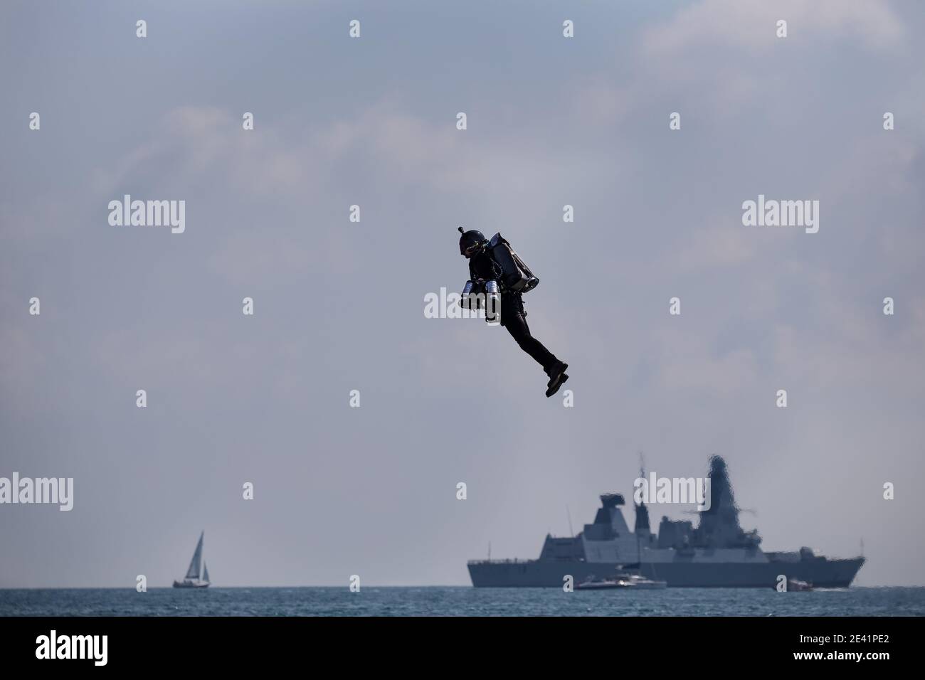Jet pack man flying above the sea Stock Photo