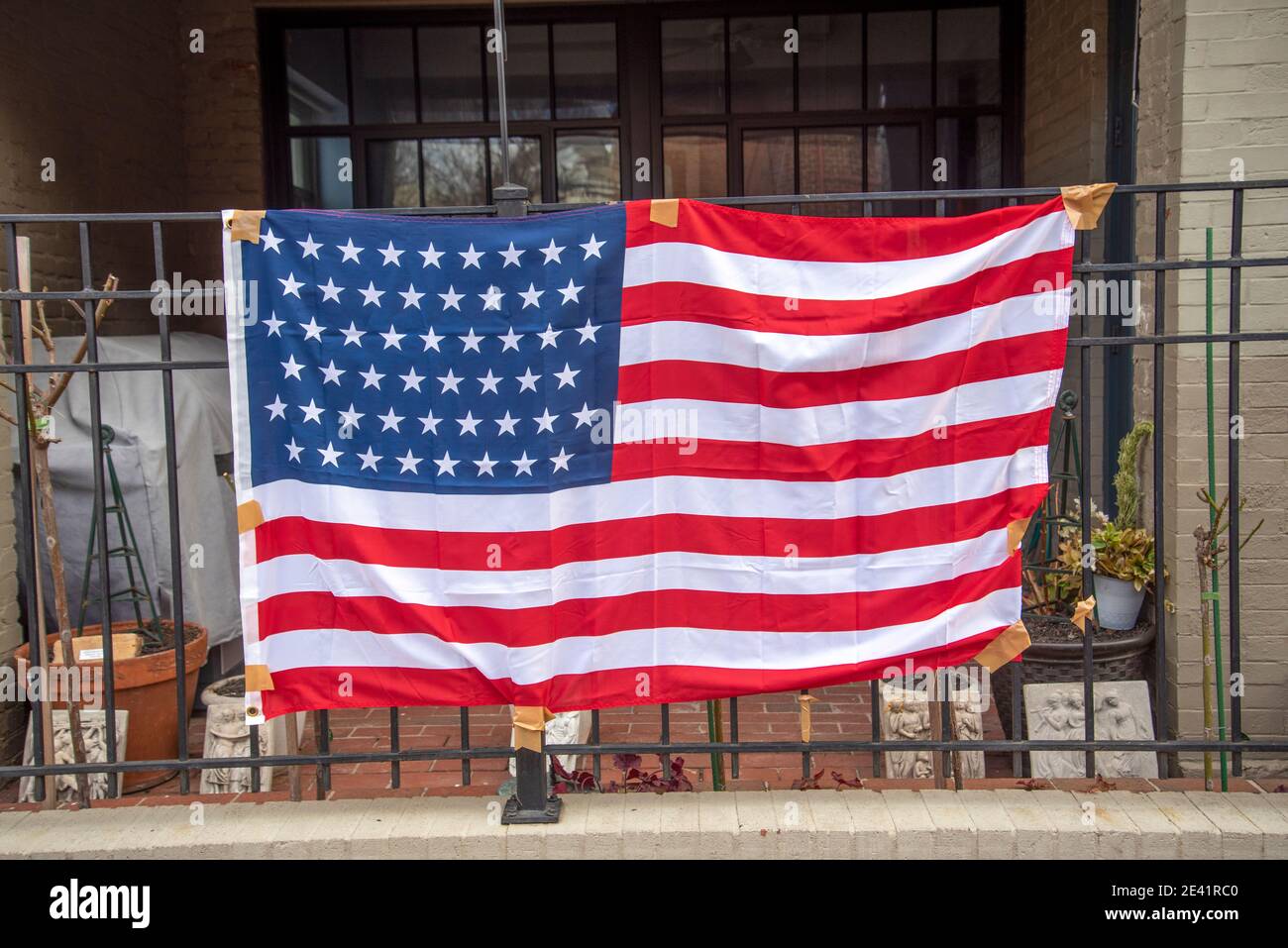 A U.S. flag, taped to a balcony railing celebrates the Inauguration of President Joe Biden, January 19, 2021. Stock Photo