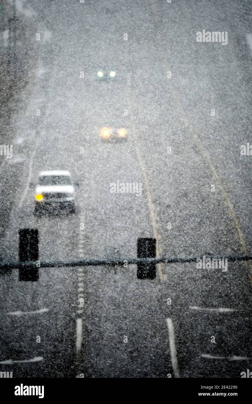 Driving in storm stormy winter snow blizzard on street with traffic