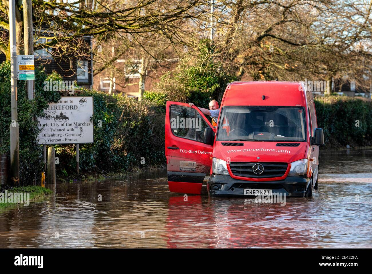 A Parcelforce delivery van is stranded in flood water in Hereford as