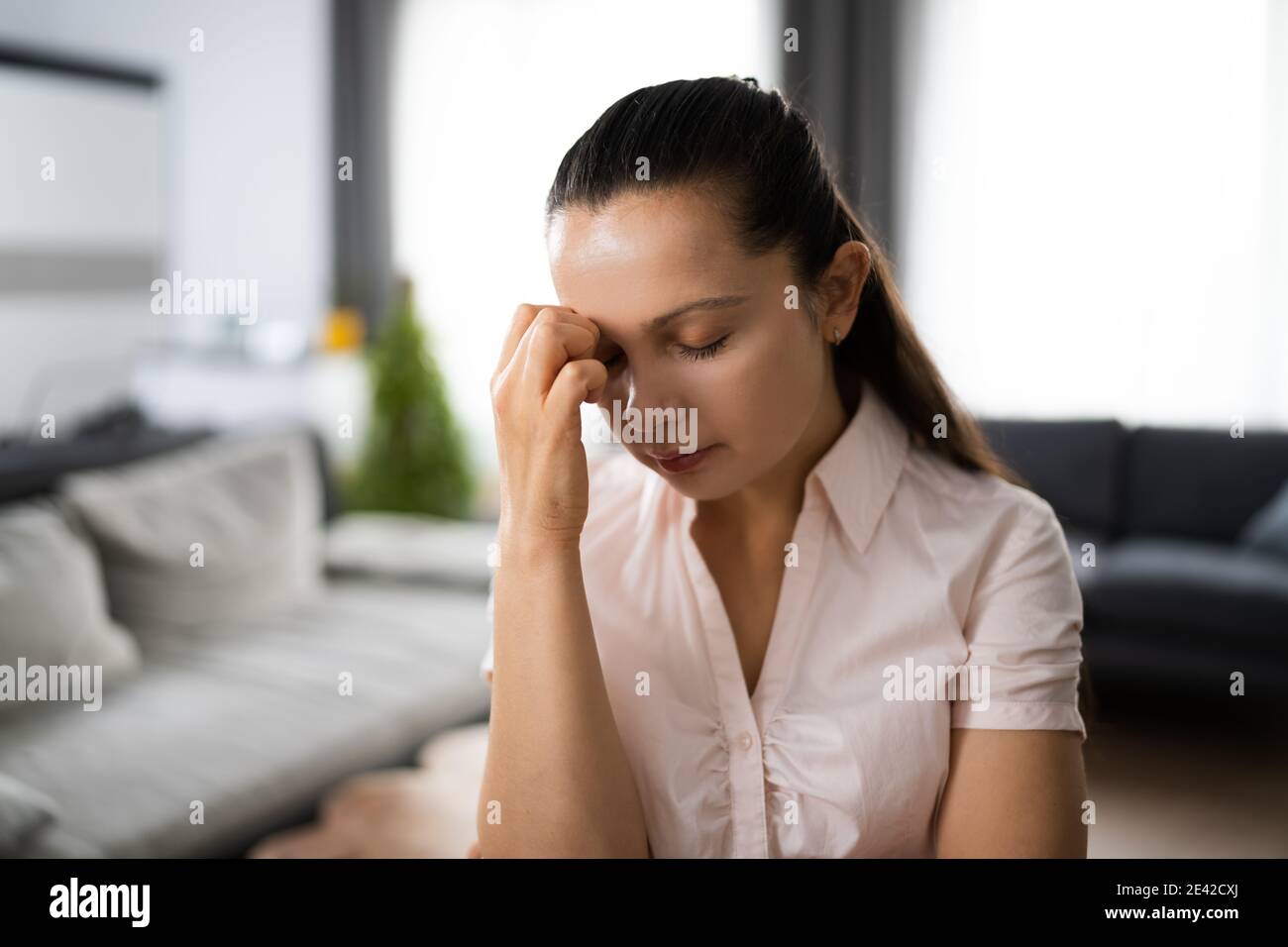 Casual Woman With Headache In Video Conference Stock Photo