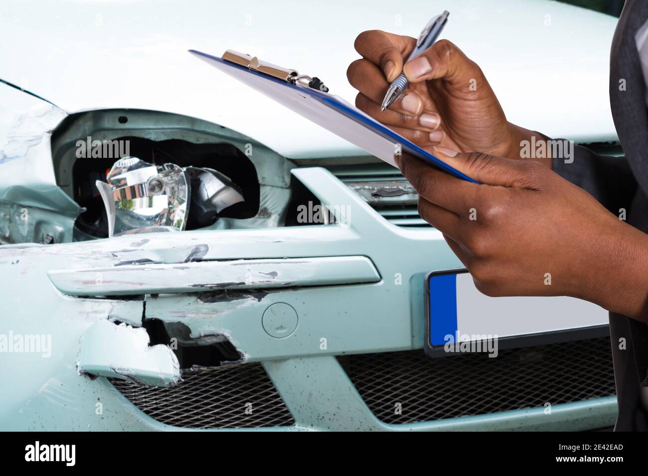 African American Car Insurance Agent Filling Accident Claim Stock Photo