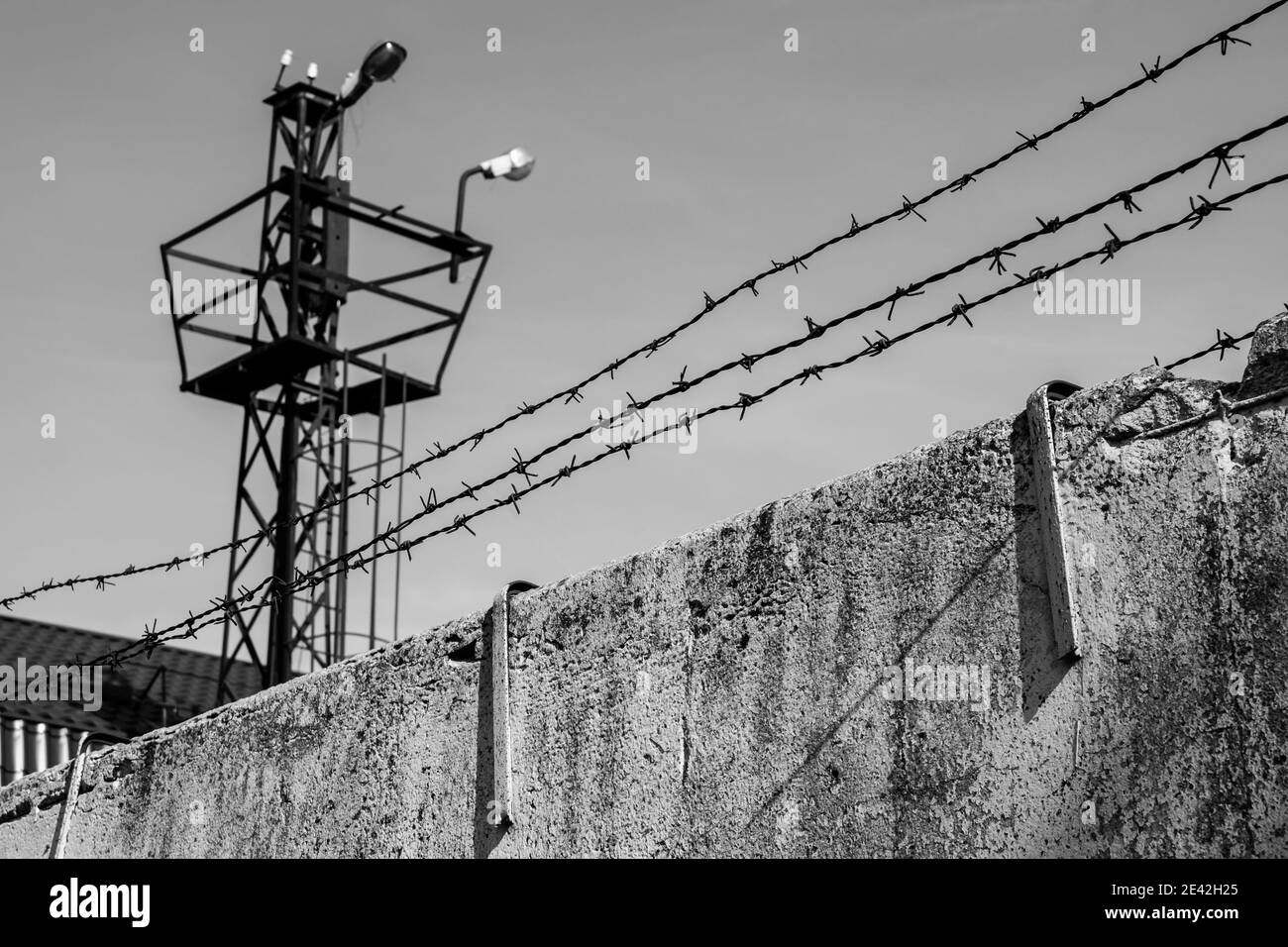 Prison fence with barbed wire, black and white grunge version Stock Photo
