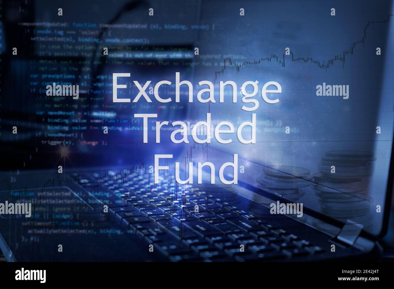 Exchange traded fund inscription against laptop and code background. Financial concept. Stock Photo