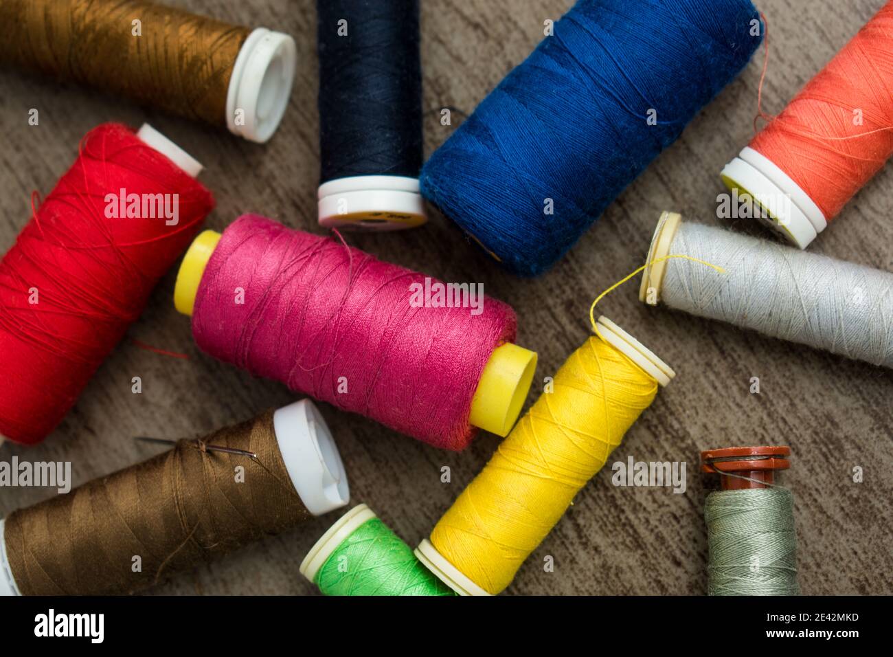 Many different colorful threads on a table in a tailor shop Stock Photo