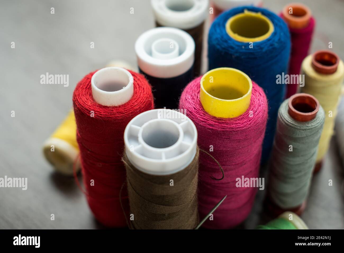 Many different colorful threads on a table in a tailor shop Stock Photo