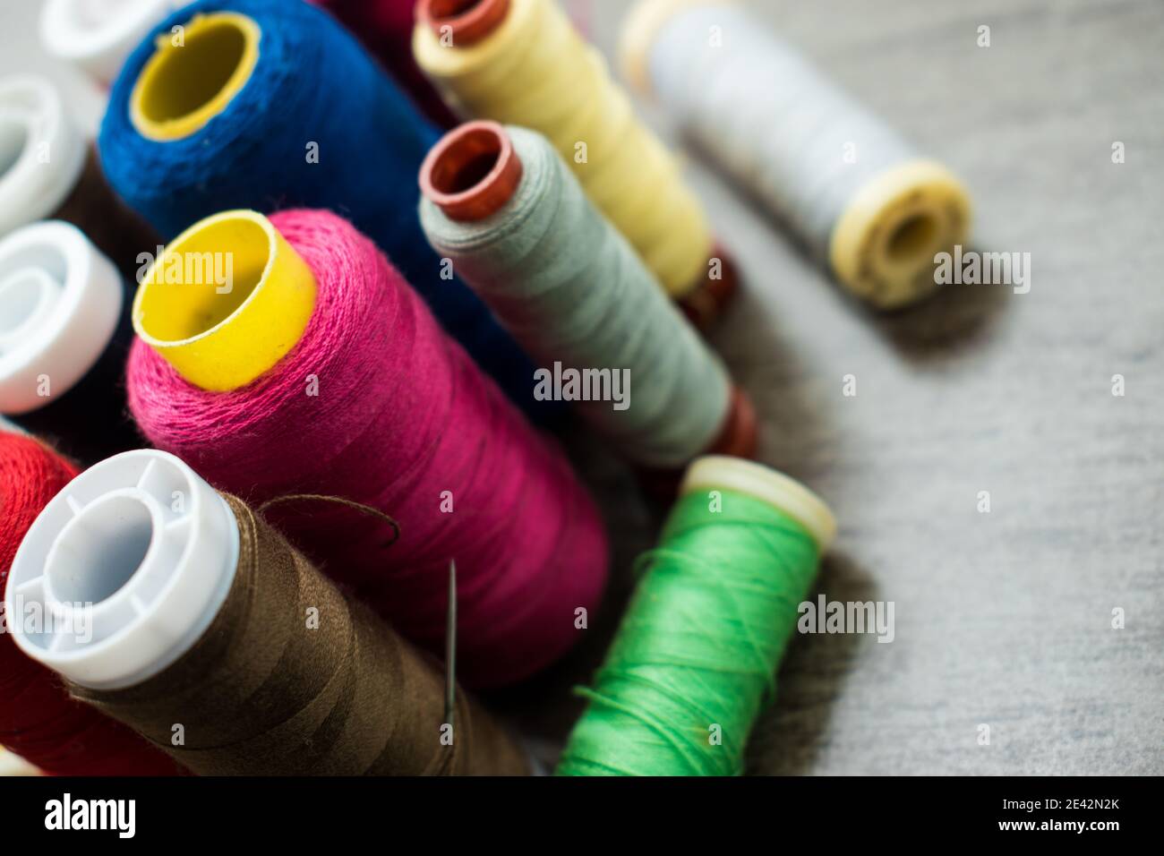 Many different colorful threads on a table in a tailor shop Stock Photo