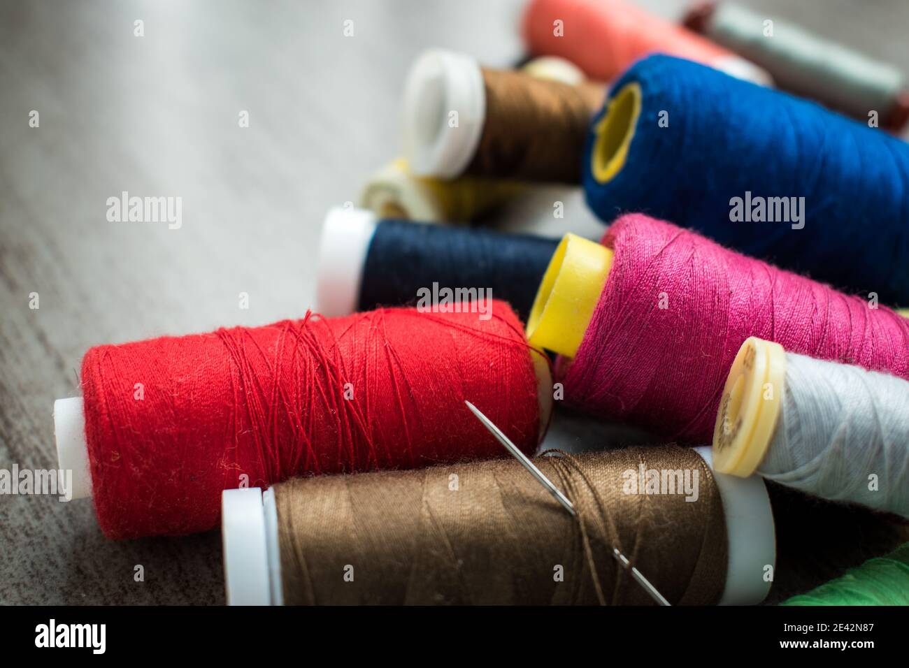 Many different colorful threads on a table in a tailor shop Stock Photo