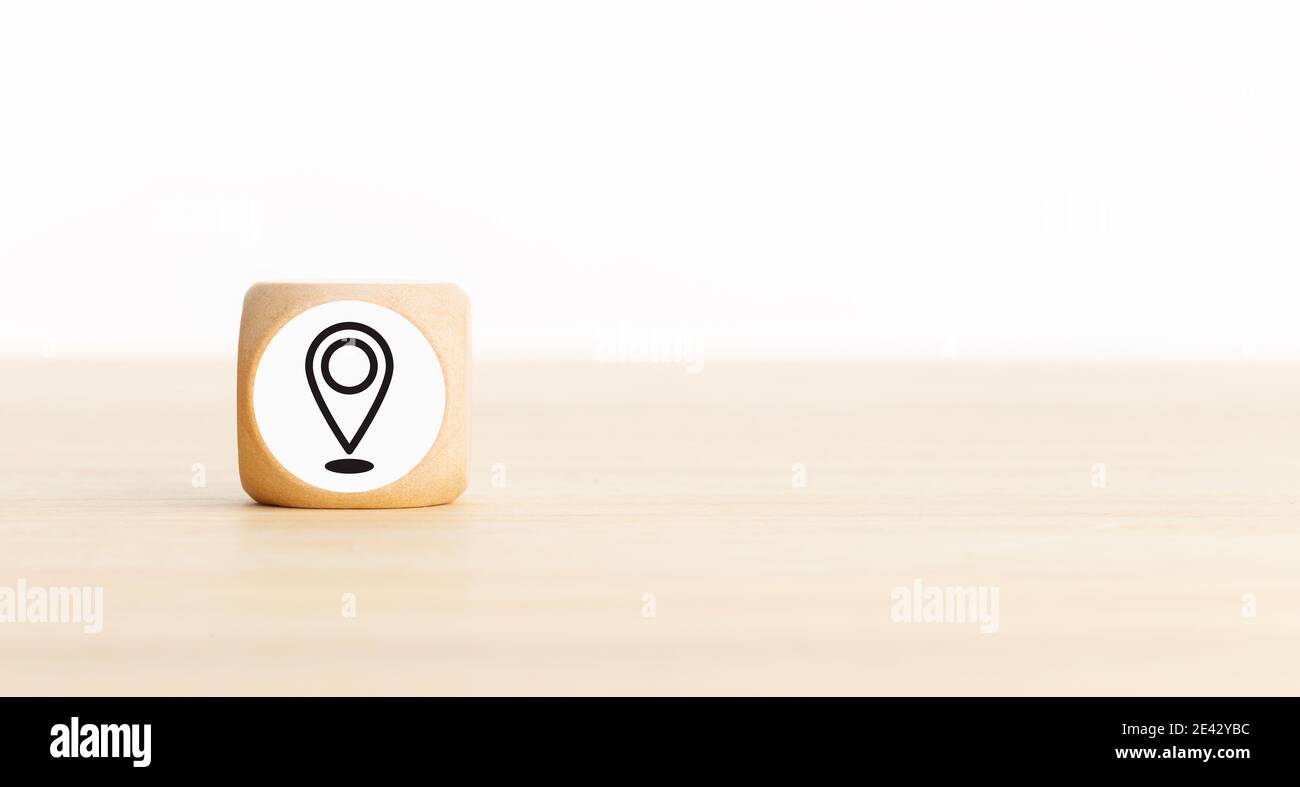 Pin Location Icon on wooden block. Copy space. White background Stock