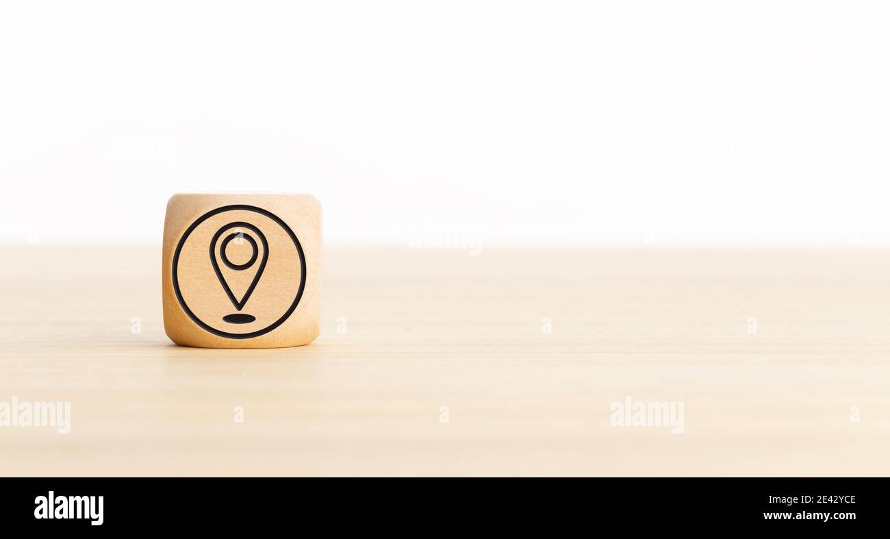 Pin Location Icon on wooden block. Copy space. White background Stock ...