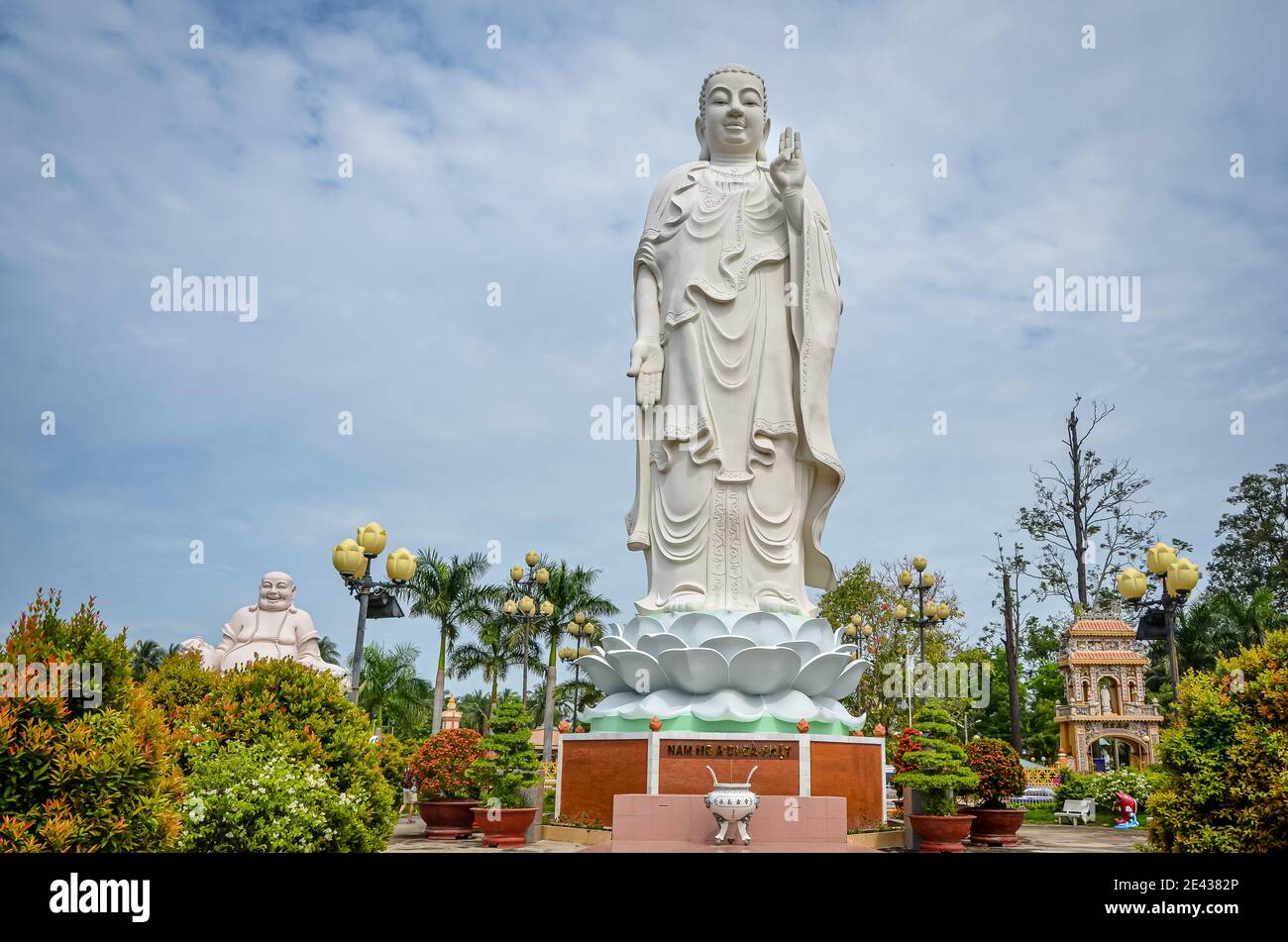 Standing Buddha statue at Vinh Trang Pagoda, Vietnam Stock Photo