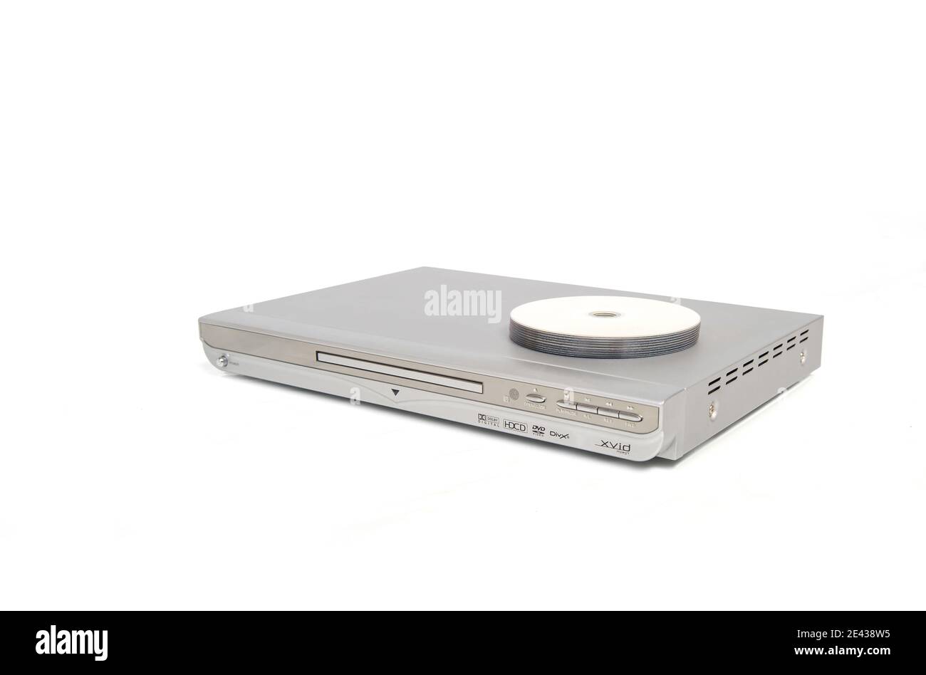 Silver colored dvd or cd player with several discs placed on top. Stock Photo